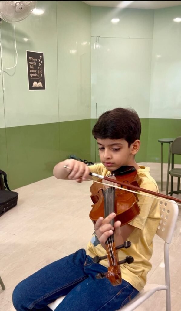 Child learning beginner violin at Jignasa music classes in Nallagandla Hyderabad